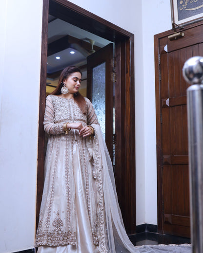 Woman in a traditional outfit standing in a doorway.