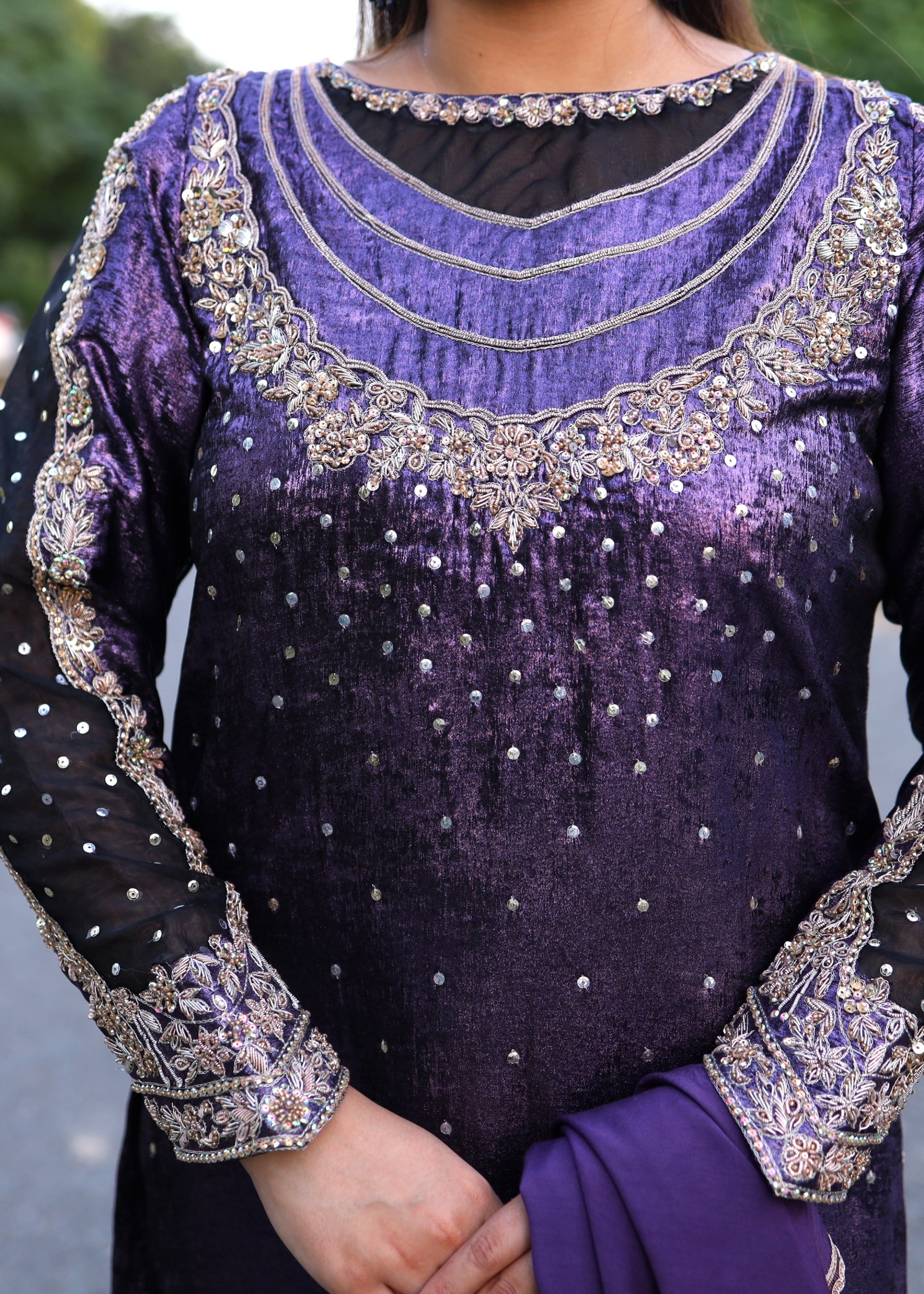 Purple traditional outfit with intricate silver embroidery