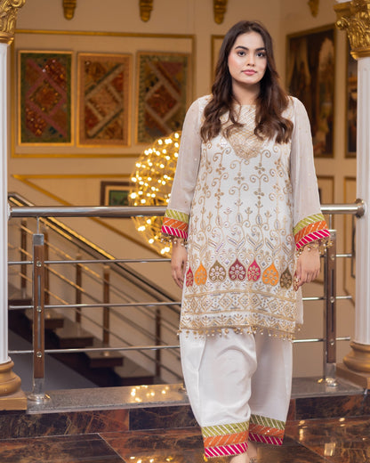 Woman in traditional outfit standing in an elegant interior setting