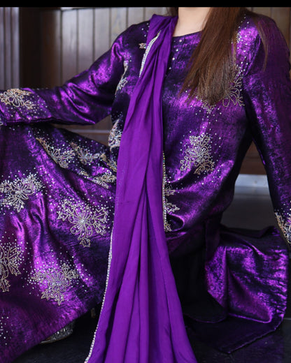 Purple embroidered outfit with a matching scarf on a neutral background