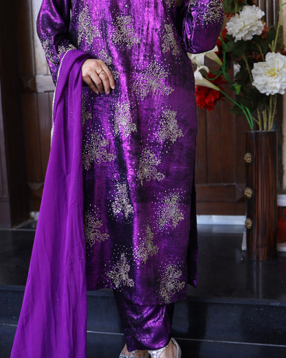 Purple traditional outfit with floral patterns on a dark background