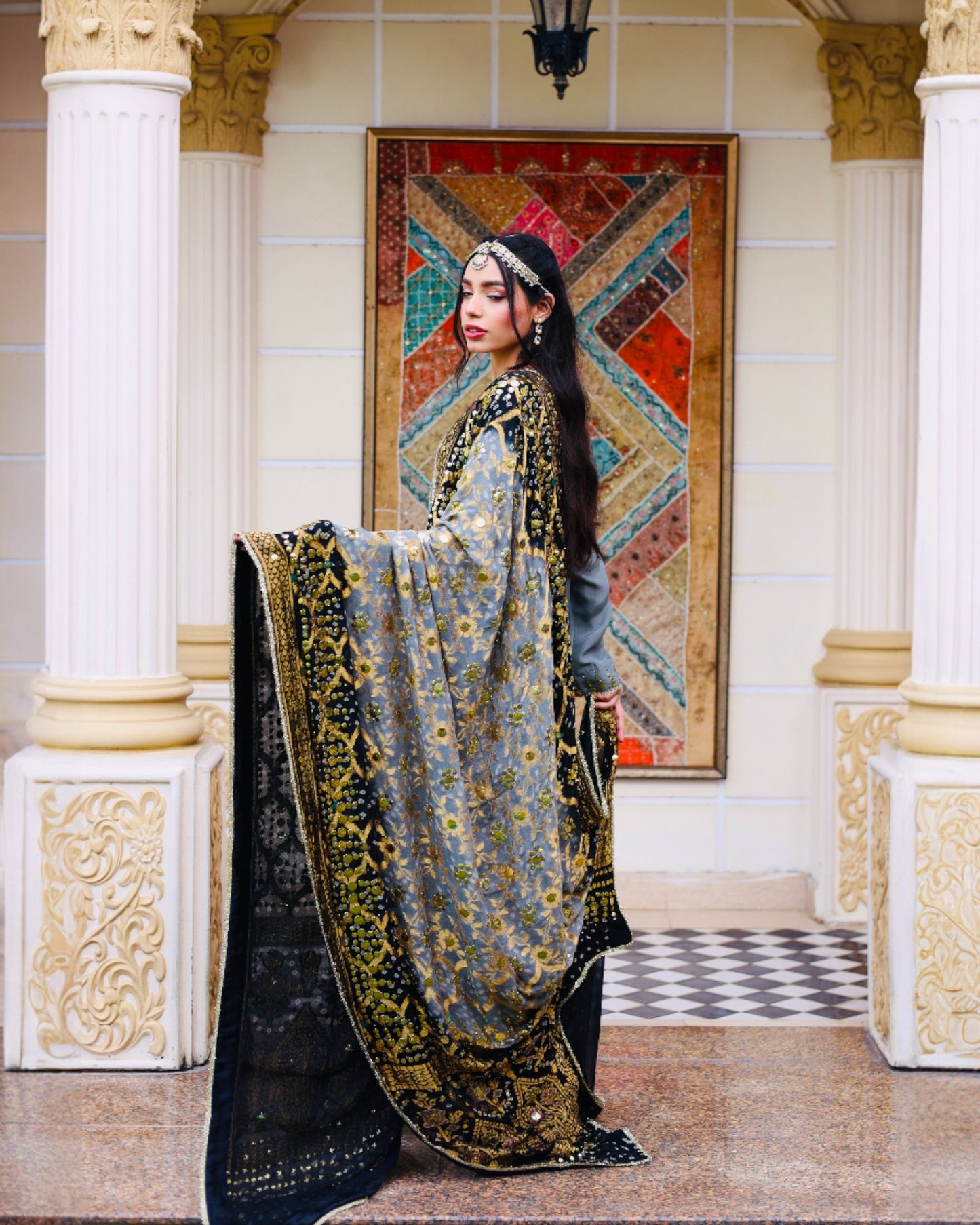 Woman in a traditional outfit with a decorative background