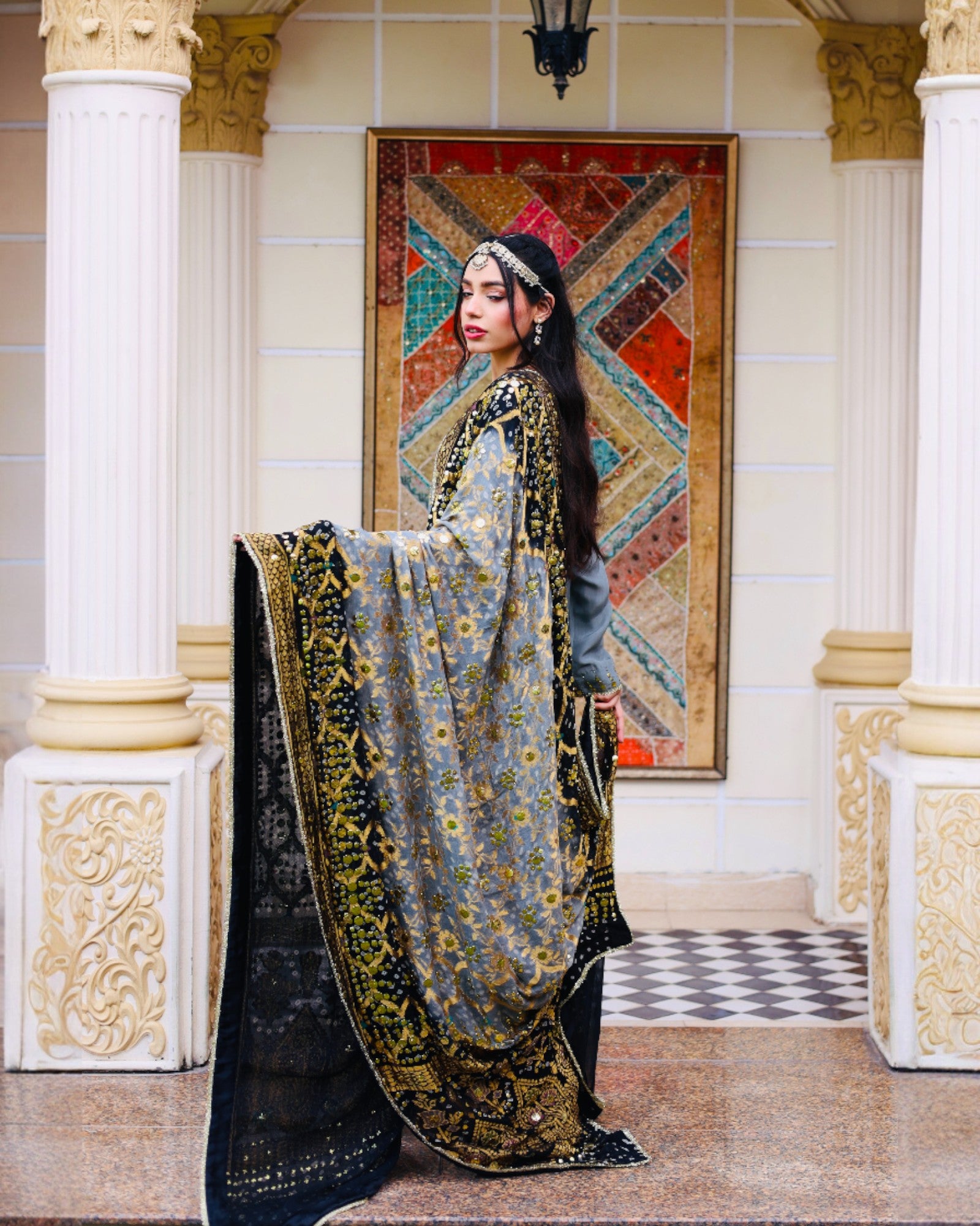 Woman in a traditional outfit with a decorative background