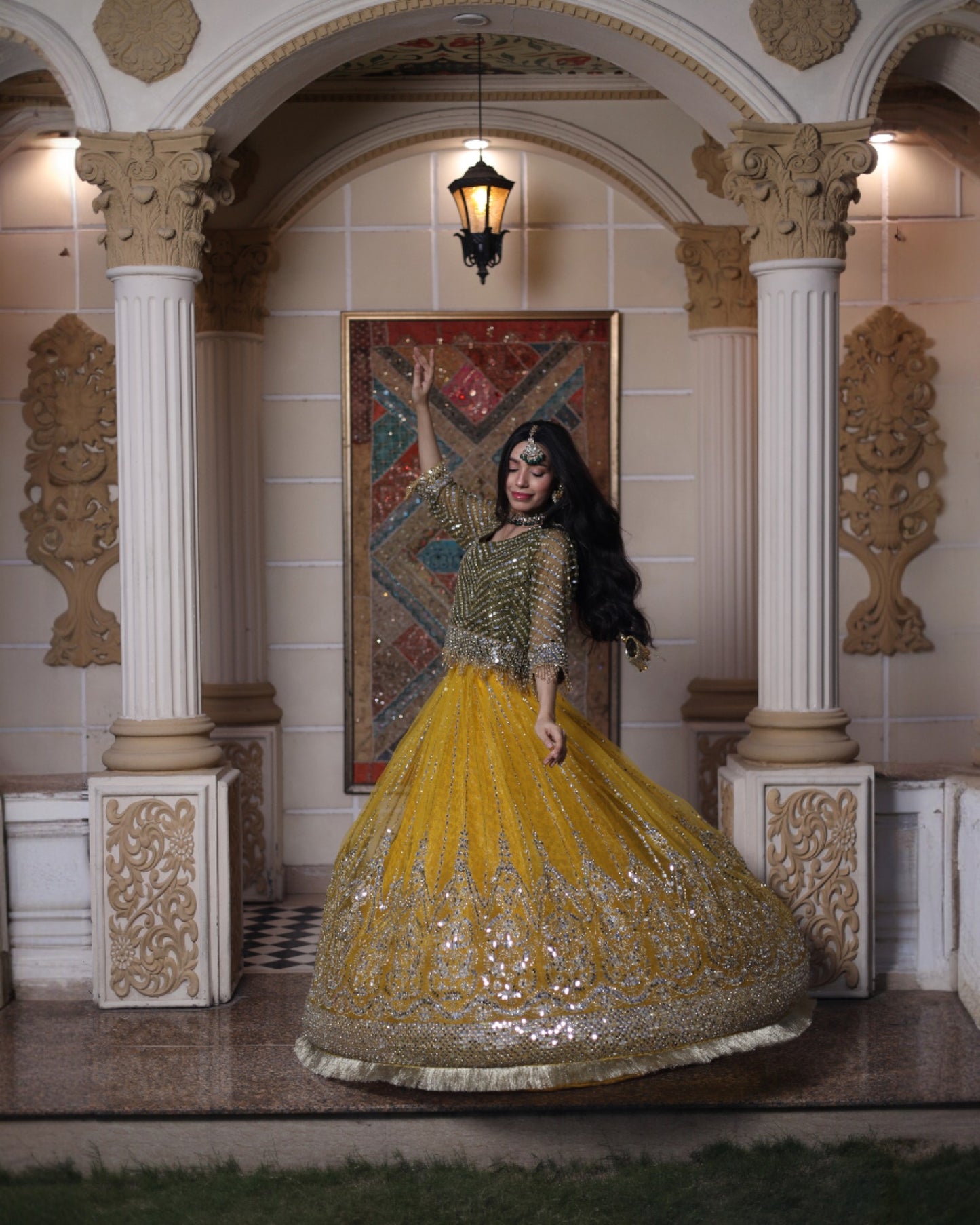Woman in a traditional outfit standing in an ornate hallway