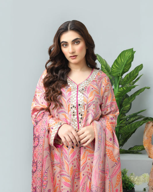 Woman wearing a colorful patterned outfit with a plant in the background