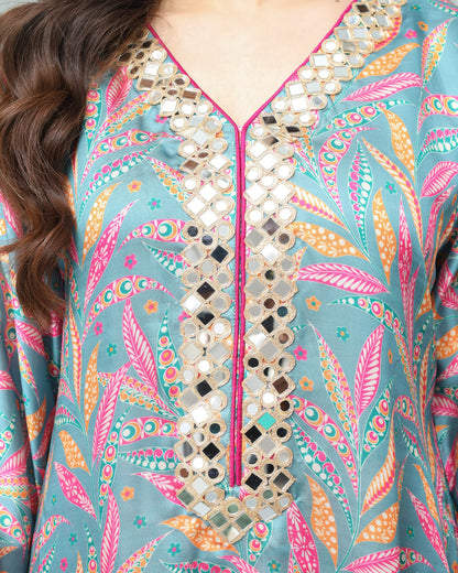Colorful embroidered garment with intricate patterns on a teal background