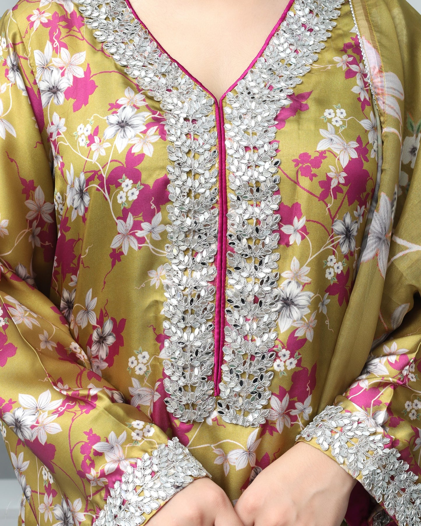 Floral dress with silver embellishments on a plain background