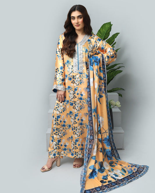 Woman wearing a yellow floral dress with a matching dupatta on a light gray background