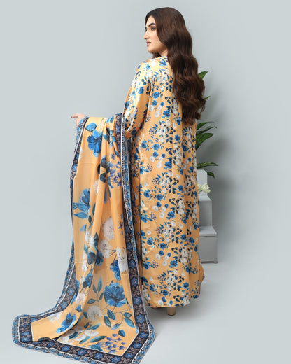 Woman wearing a yellow floral dress with a blue border on a gray background