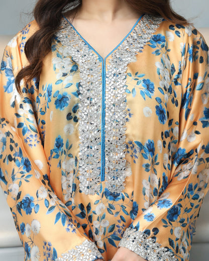 Yellow floral dress with silver sequin detailing on a neutral background